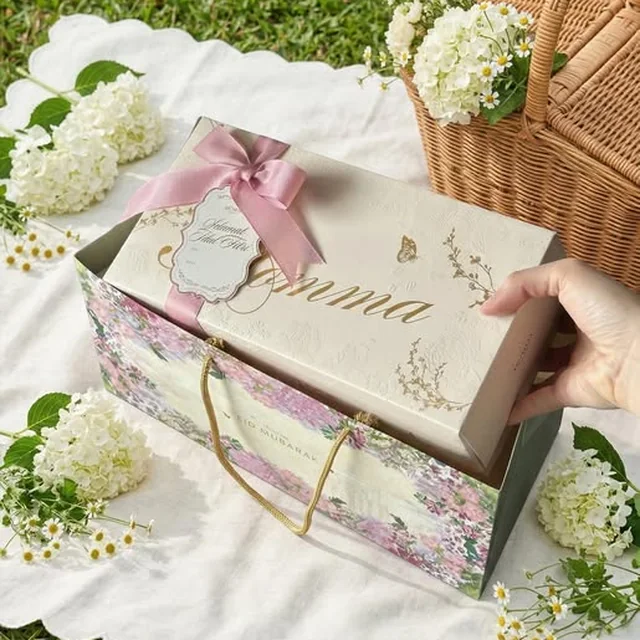 A ribboned Momma Jakarta gift box being opened